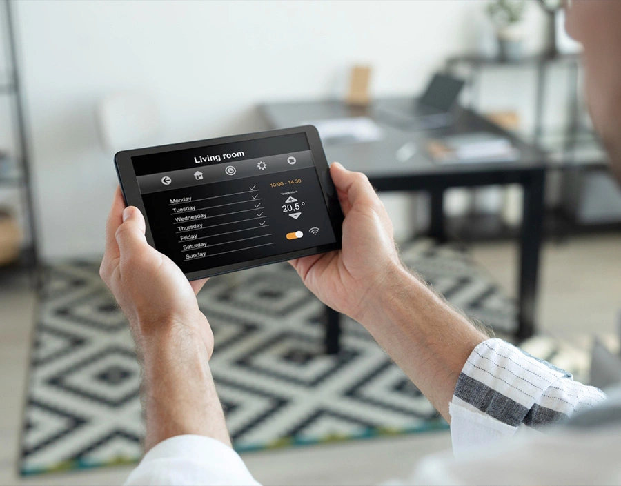Man using a smart home tablet indoors