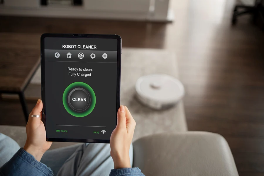 Someone is controling Robot Cleaner via software on tablet in Smart Home