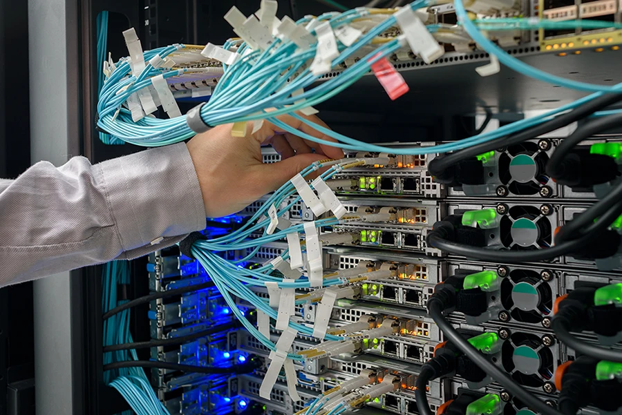 Technician hand is working on data center and performing server maintenance